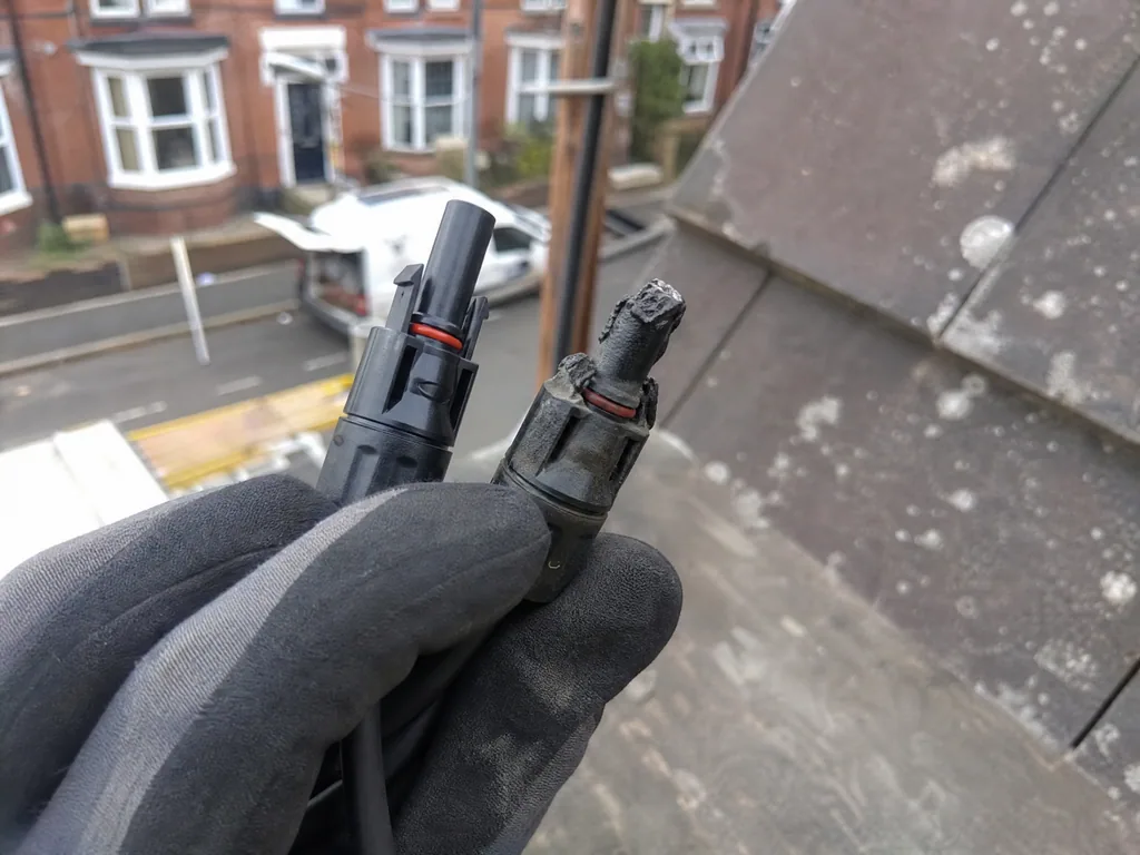 Scorched solar connector next to its replacement during a repair, Derby